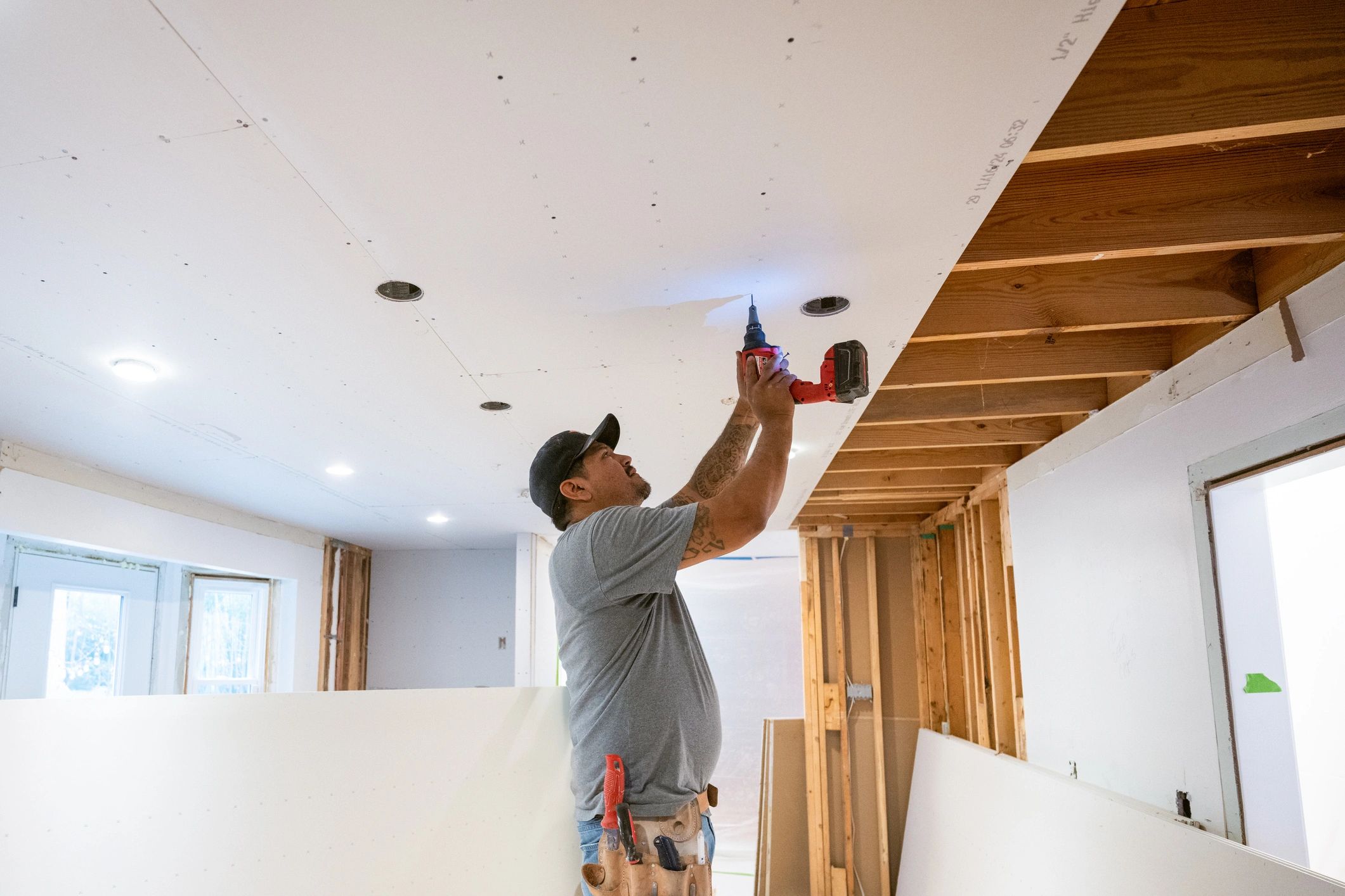Drywall installers working in kitchen renovation